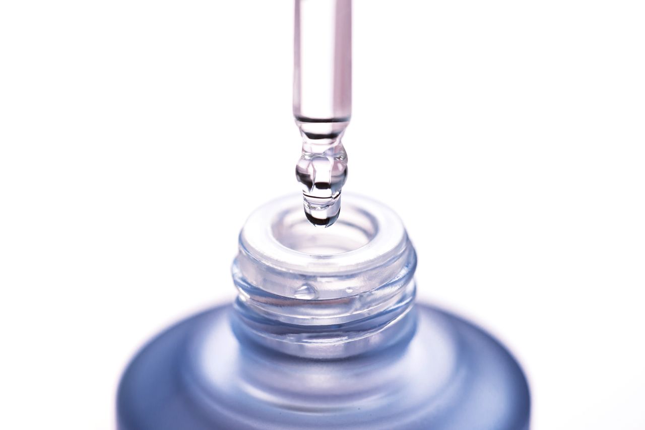 beta hydroxy acid main closeup image of dropper with clear serum