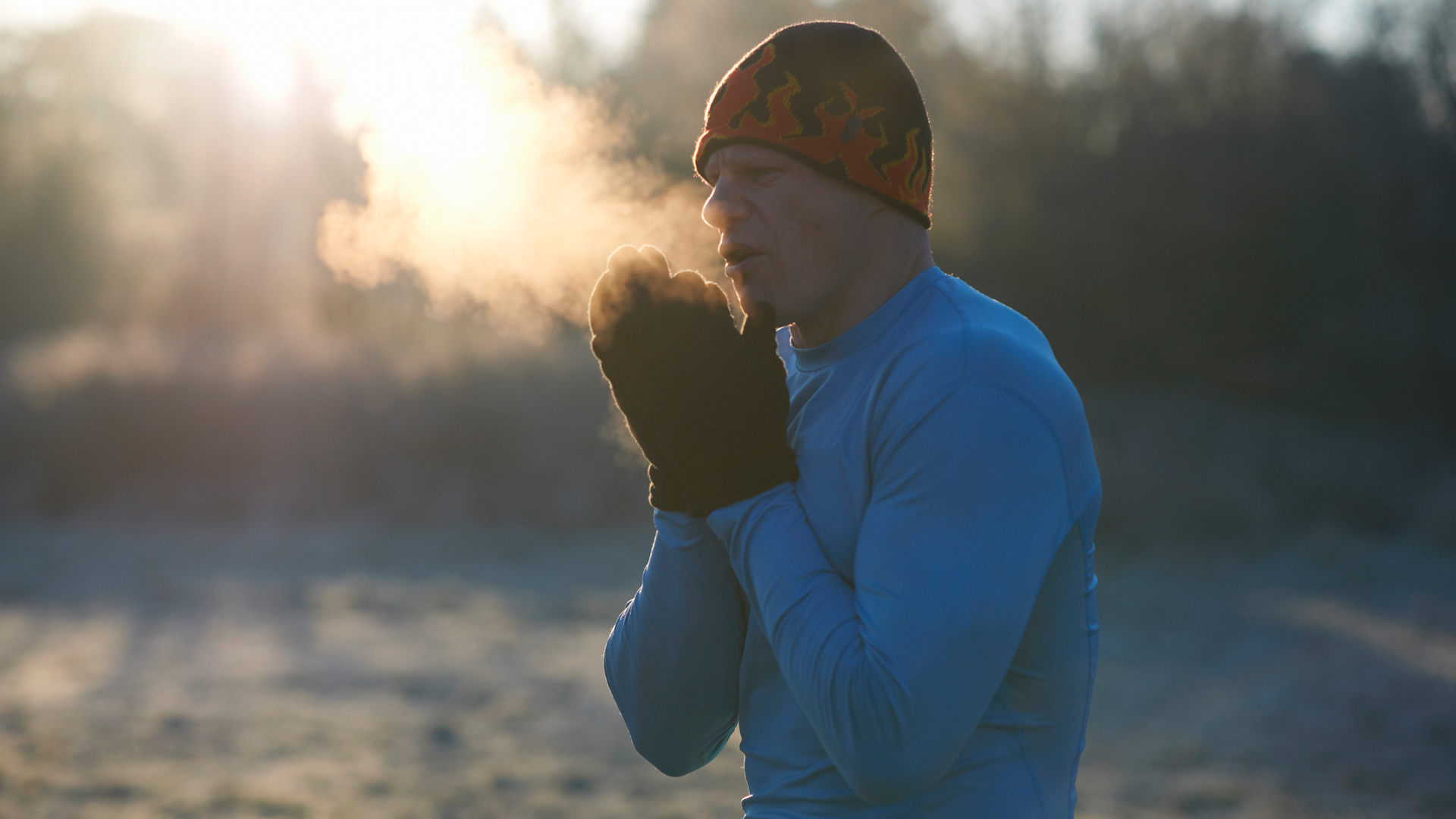 man trying to keep warm during a winter run