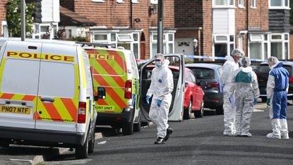 Forensic police outside a house in the Knotty Ash area in Liverpool