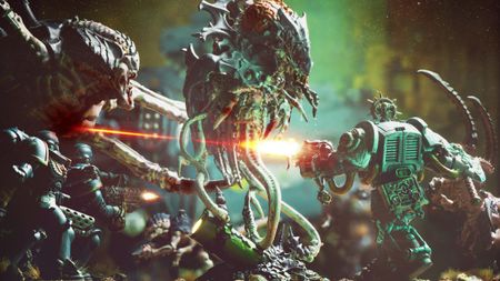 A scene composed from Warhammer miniature figures with a Space Marine firing a laser gun towards aliens