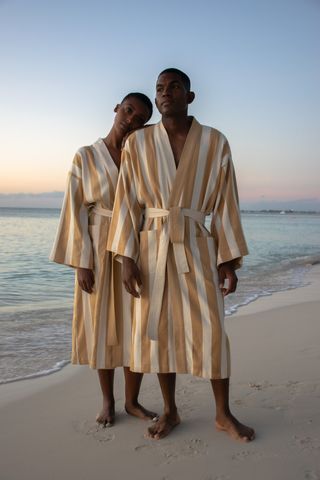 Man and woman in striped beachwear robes