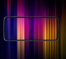 The Motorola Razr 2022 fully opened on its side with a multicoloured wallpaper which extends into the background
