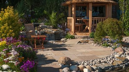landscaping with river rocks: patio scene with gazebo