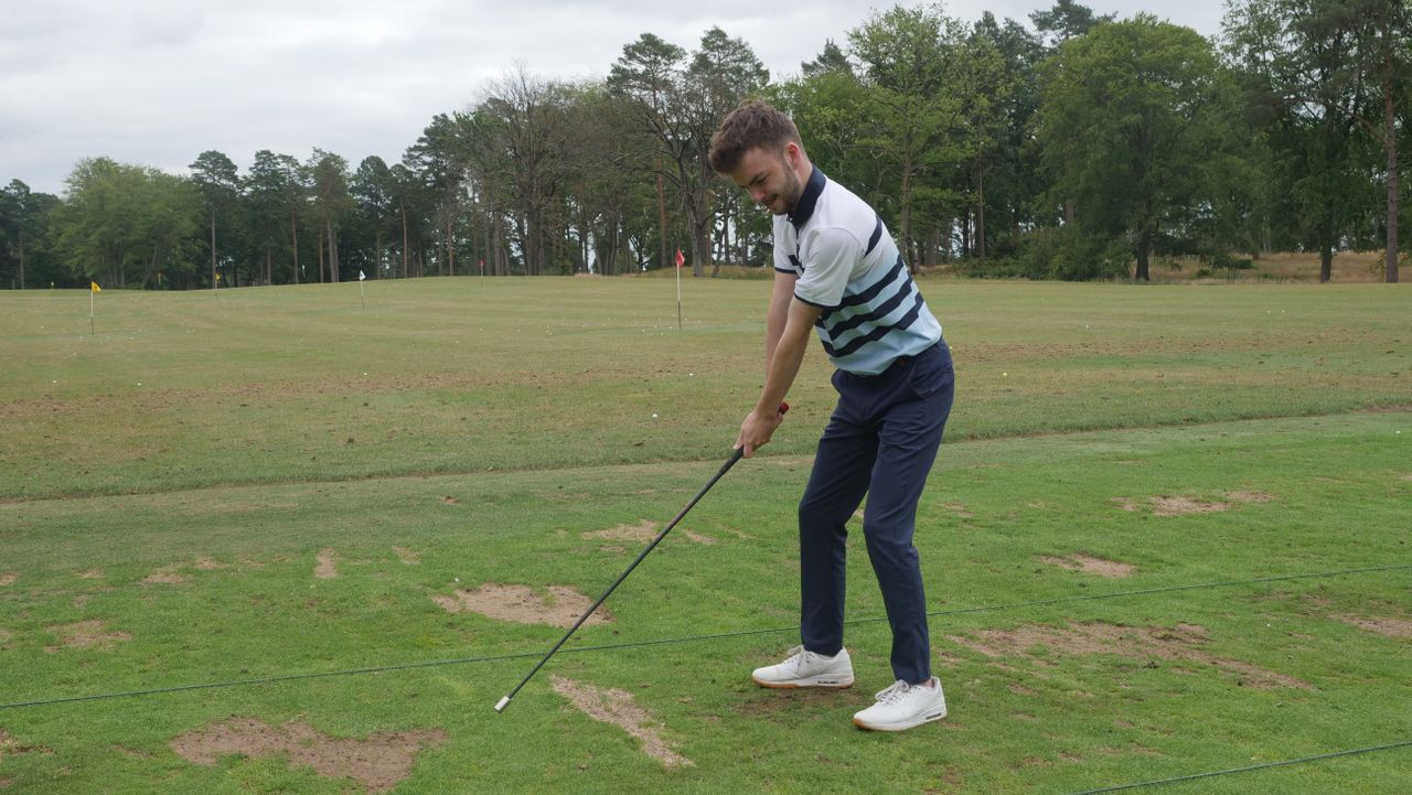 A golfer swinging with the SuperSpeed C Club