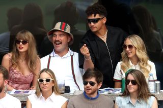 From left to right: Taylor Swift, Travis Kelce wearing a bucket hat, Patrick Mahomes and Brittany Mahomes at the Men's Singles Final match between Taylor Fritz and Jannik Sinner at the 2024 US Open.