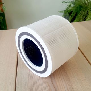 The air filter from the Levoit Core 300S air purifier on a wooden tabletop