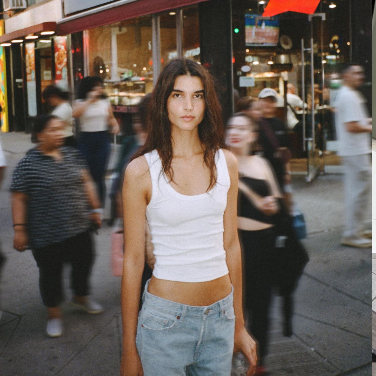 woman wearing tank top and jeans