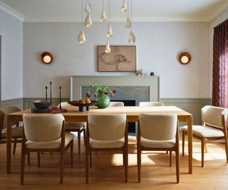 dining room with fireplace and cream chairs with wooden table