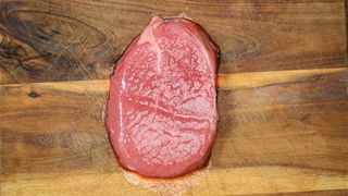 A raw steak on a wooden board - Header image for Sean McCormack opinion piece on shooting in Raw