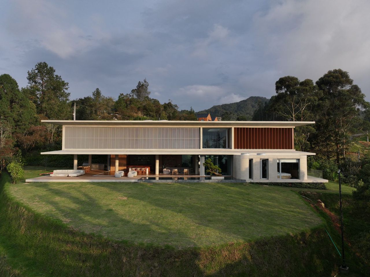 casa cuore exterior, concrete geometric forms among greenery