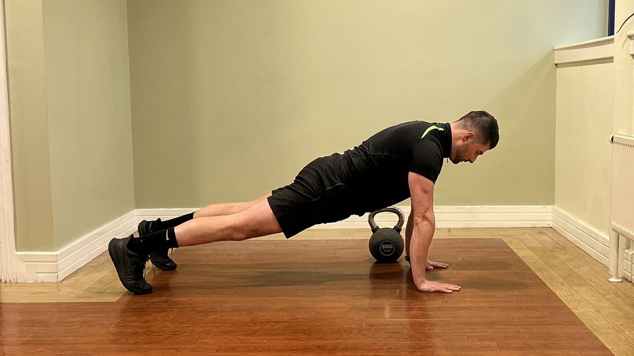 Sam Quinn, strength coach from Nuffield Health, demonstrates a kettlebell pull through