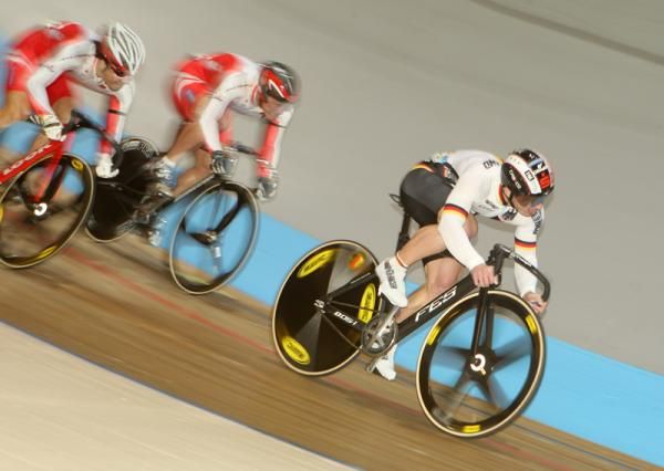 Rene Emders (Germany) holds off the challenge from the Japanese riders to win through to round two via the repechage.