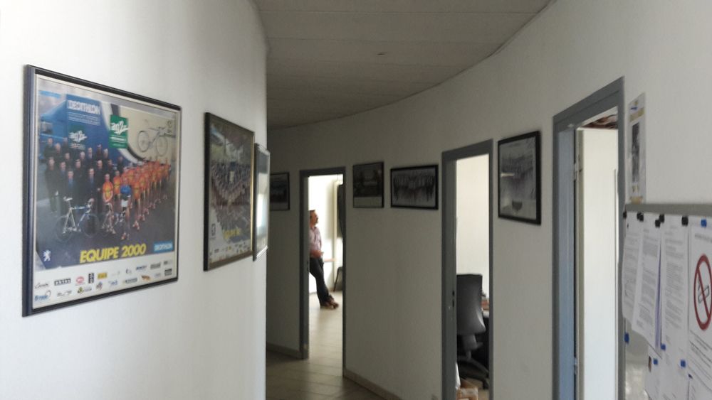 The semi-circular corridors are lined with photos of the team