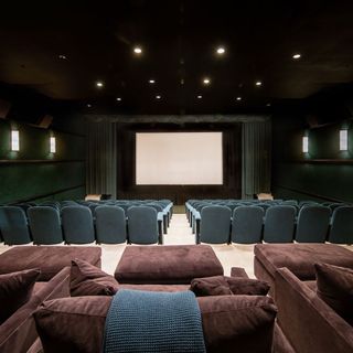 theatre with blue arm chairs and red cushions