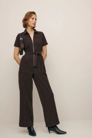 reformation winter sale woman wearing brown cord jumpsuit