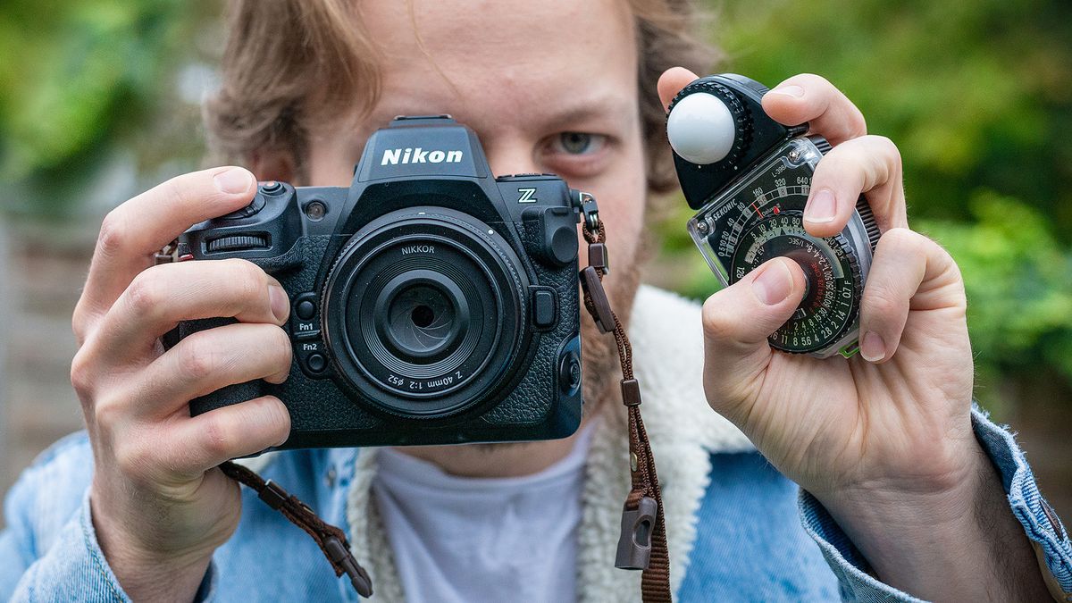 Sekonic Studio Deluxe III L-398A being held by man holding Nikon Z8