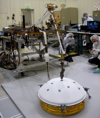 Engineers test the robotic arm on NASA's Insight Mars lander, which is scheduled to launch toward the Red Planet in March 2016.