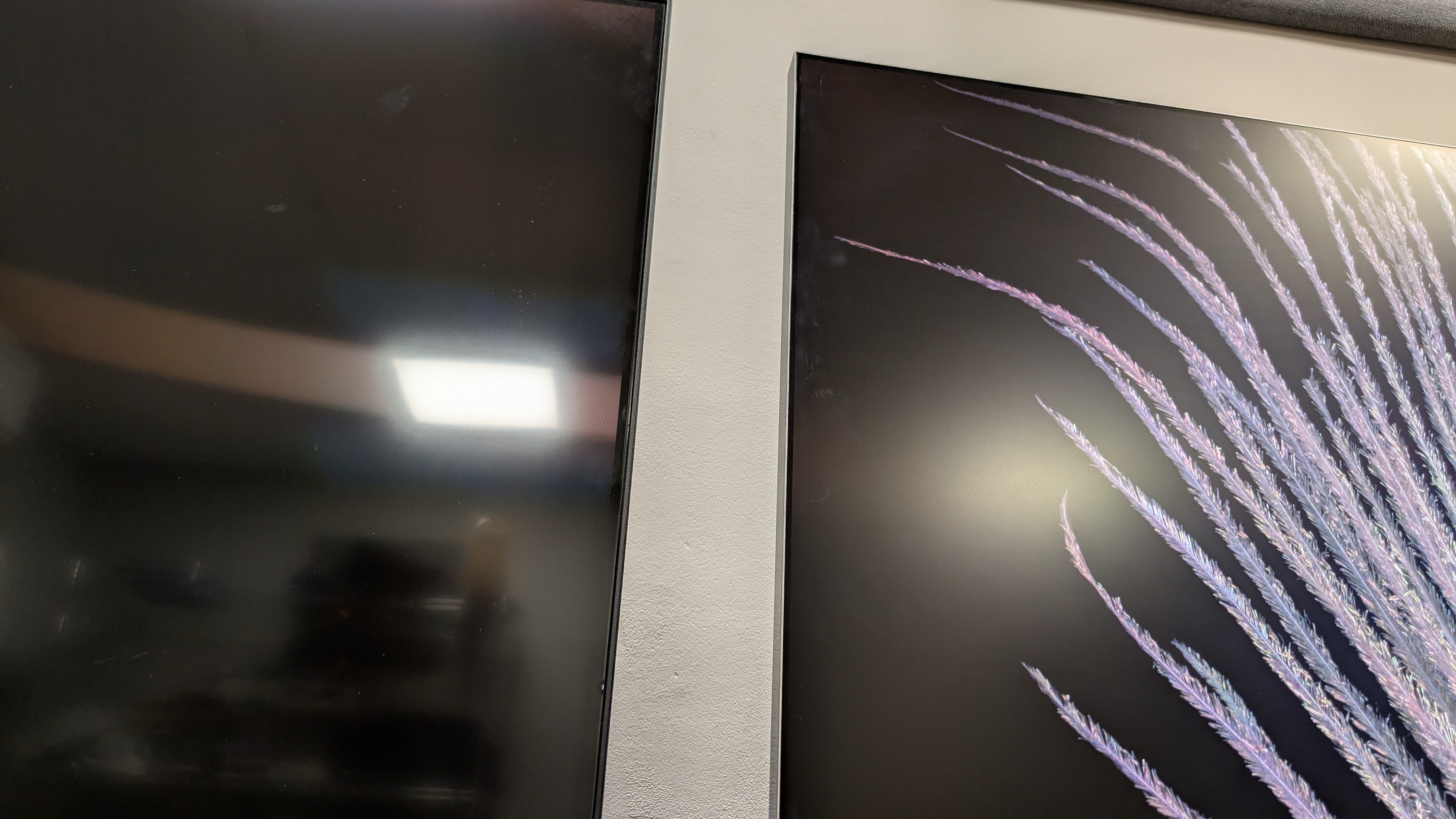 Sony Bravia 7 II (left) vs Samsung R95H (right) showing overhead light refelcted in screen. The R95H's anti-glare screen is much more effective than the Braiva 7 II's.