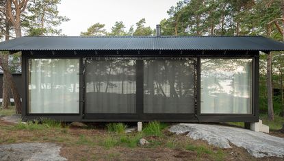 long view of swedish A house cabin in woods