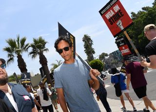 Danny Pudi walks a picket line in California.