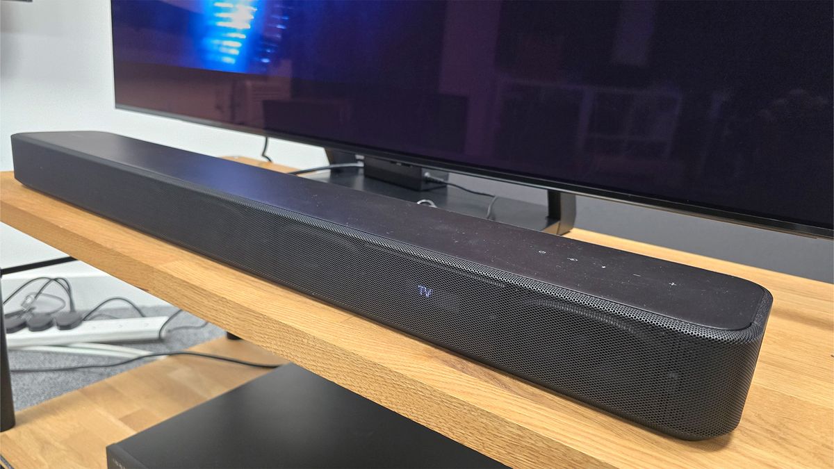 Sony HT-S2000 soundbar on a rack in front of a TV