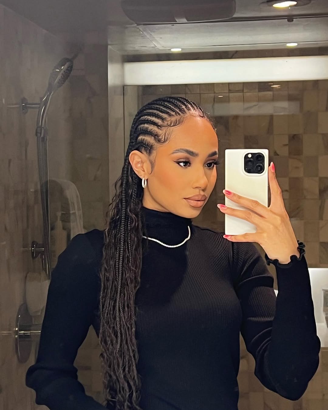 Symphani Soto wears waist-length straight back braids with added curls
