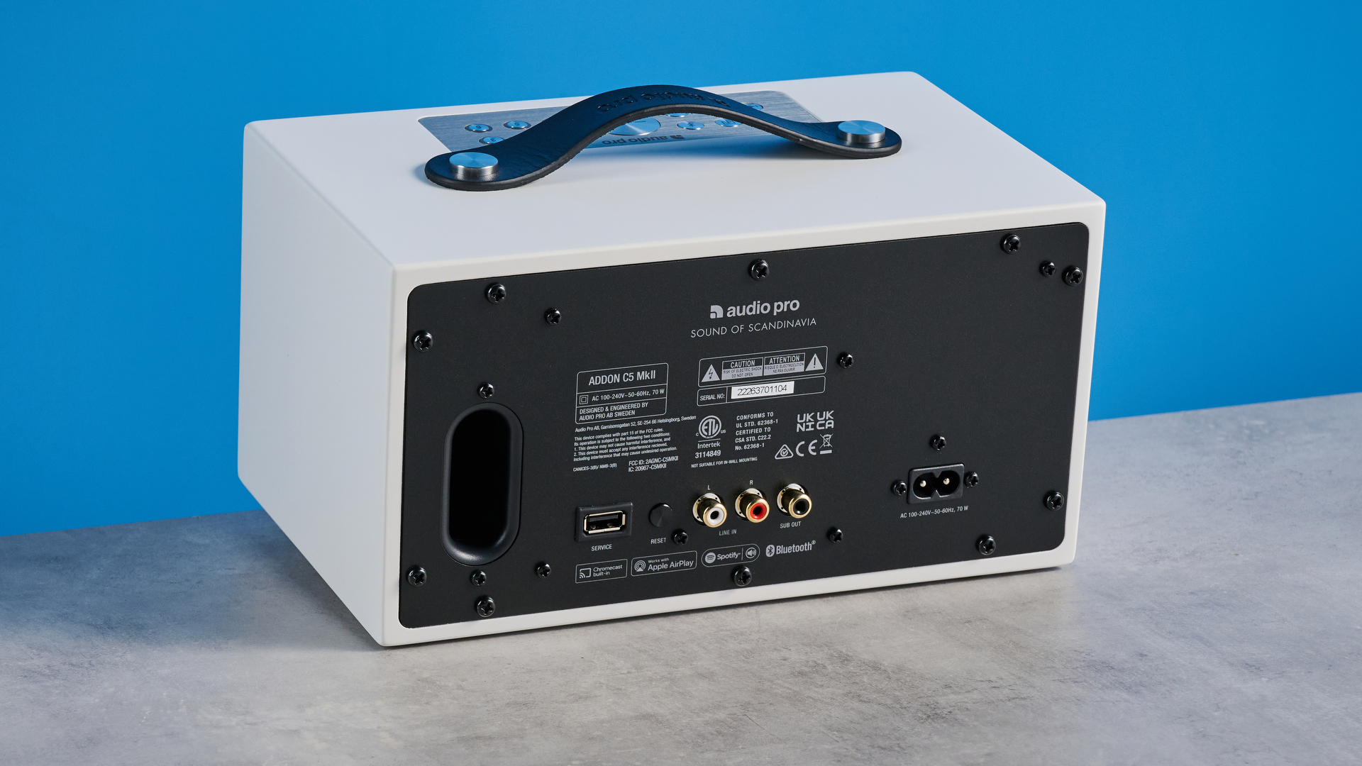 Audio Pro C5 MKII Bluetooth speaker in white photographed on a blue background