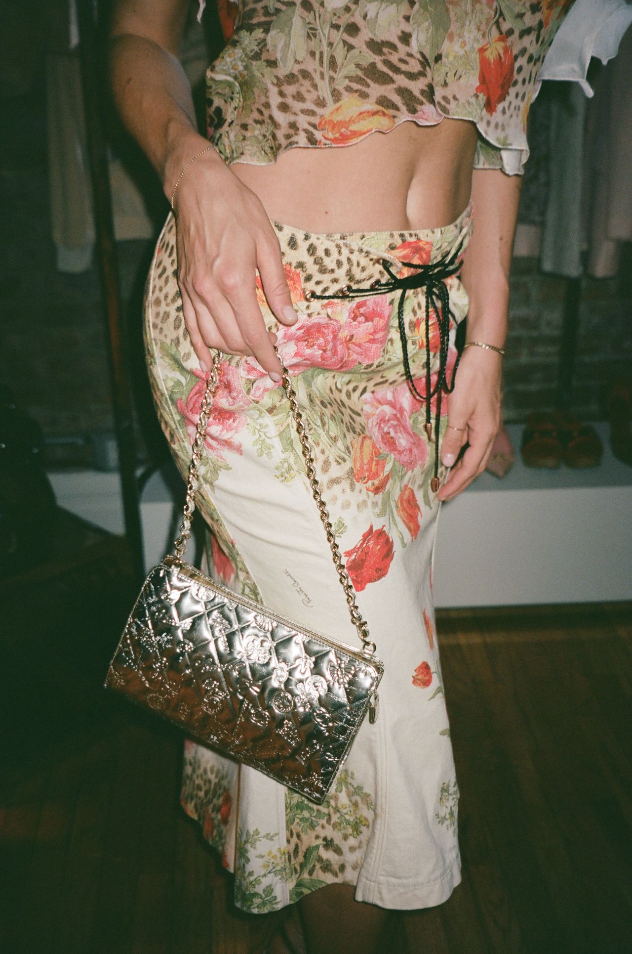 Kathryn Zahorak in floral midi skirt with silver bag