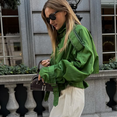 Anne-Laure Mais wearing a green funnel-neck jacket in Paris