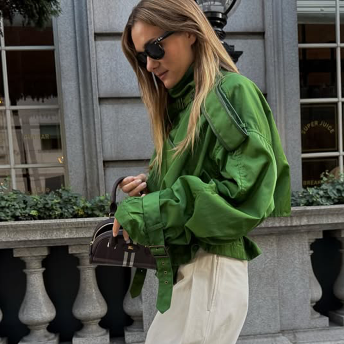 Anne-Laure Mais wearing a green funnel-neck jacket in Paris