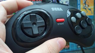 Sega Mega Drive Mini 2 review; a hand holds a controller