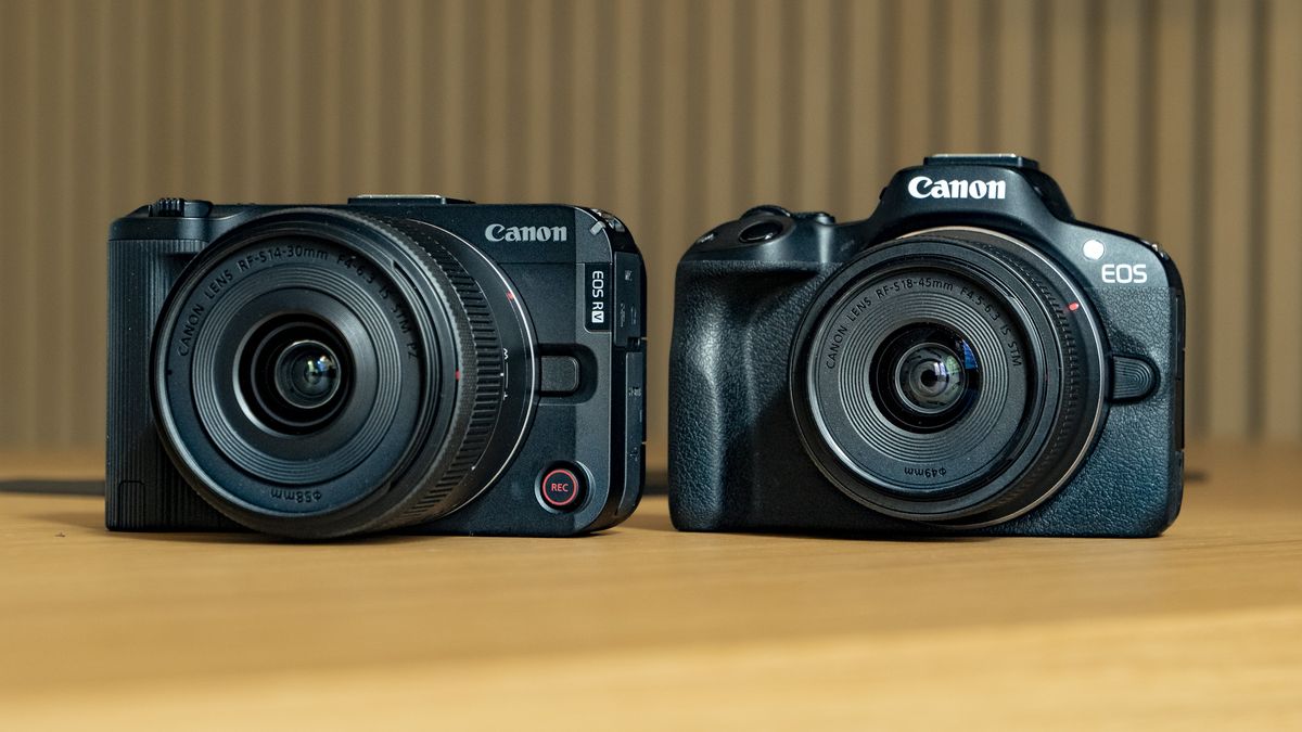 Canon EOS R50 V on a wooden table, alongside the EOS R50