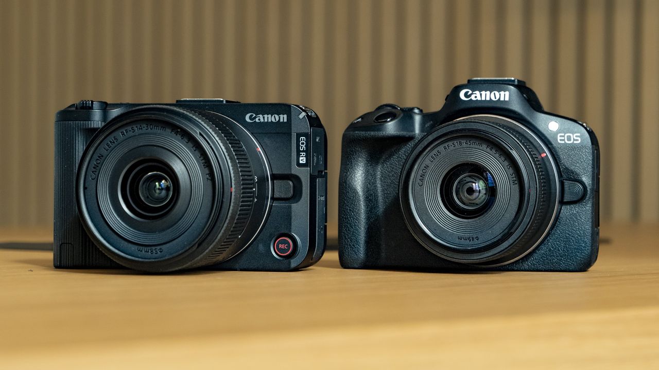 Canon EOS R50 V on a wooden table, alongside the EOS R50