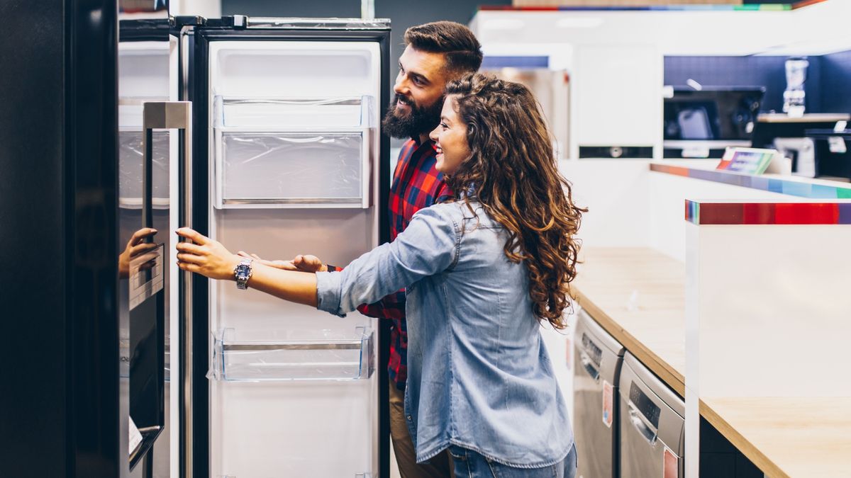 male and female couple shopping for a refrigerator 