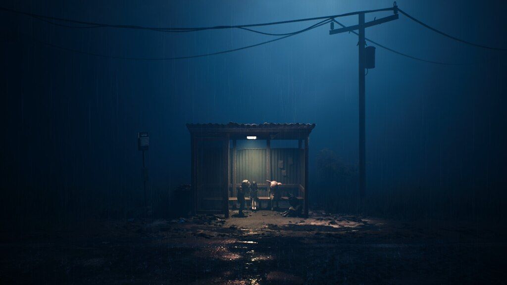 Small figures stand at a bus stop by night
