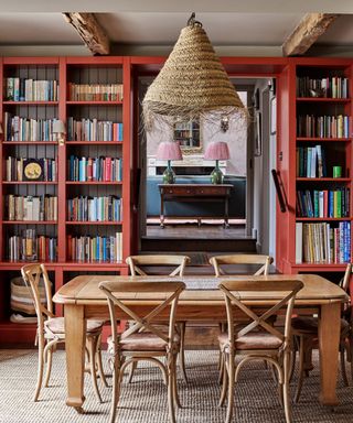 Red dining room with book shelves