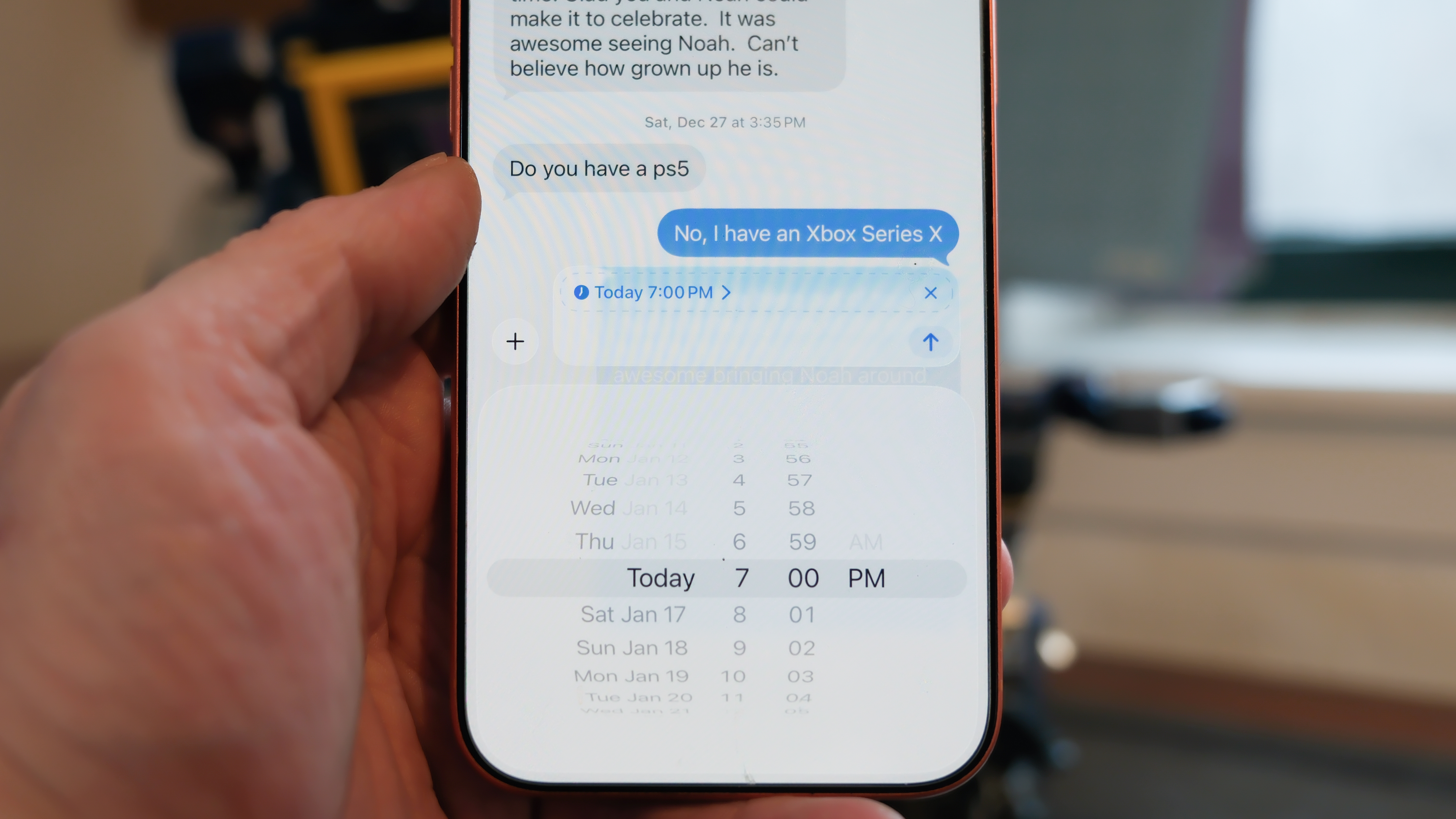 Apple iPhone 16 Pro Max in orange showing various Apple Messages features including sending check-ins, Apple Cash, and doodles
