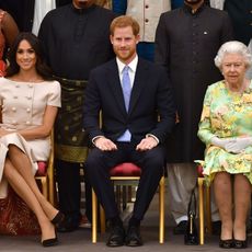 london, england june 26 meghan, duchess of sussex, prince harry, duke of sussex and queen elizabeth ii at the queens young leaders awards ceremony at buckingham palace on june 26, 2018 in london, england the queens young leaders programme, now in its fourth and final year, celebrates the achievements of young people from across the commonwealth working to improve the lives of people across a diverse range of issues including supporting people living with mental health problems, access to education, promoting gender equality, food scarcity and climate change photo by john stillwell wpa poolgetty images