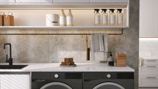 Modern and luxury counter, cabinet and shelf with white granite top and black washing machine sunlight from window on cement tile wall laundry room for washing and cleaning product display