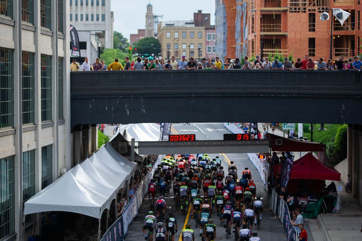 Fans watch as the mens race rolls along the course during the criterium