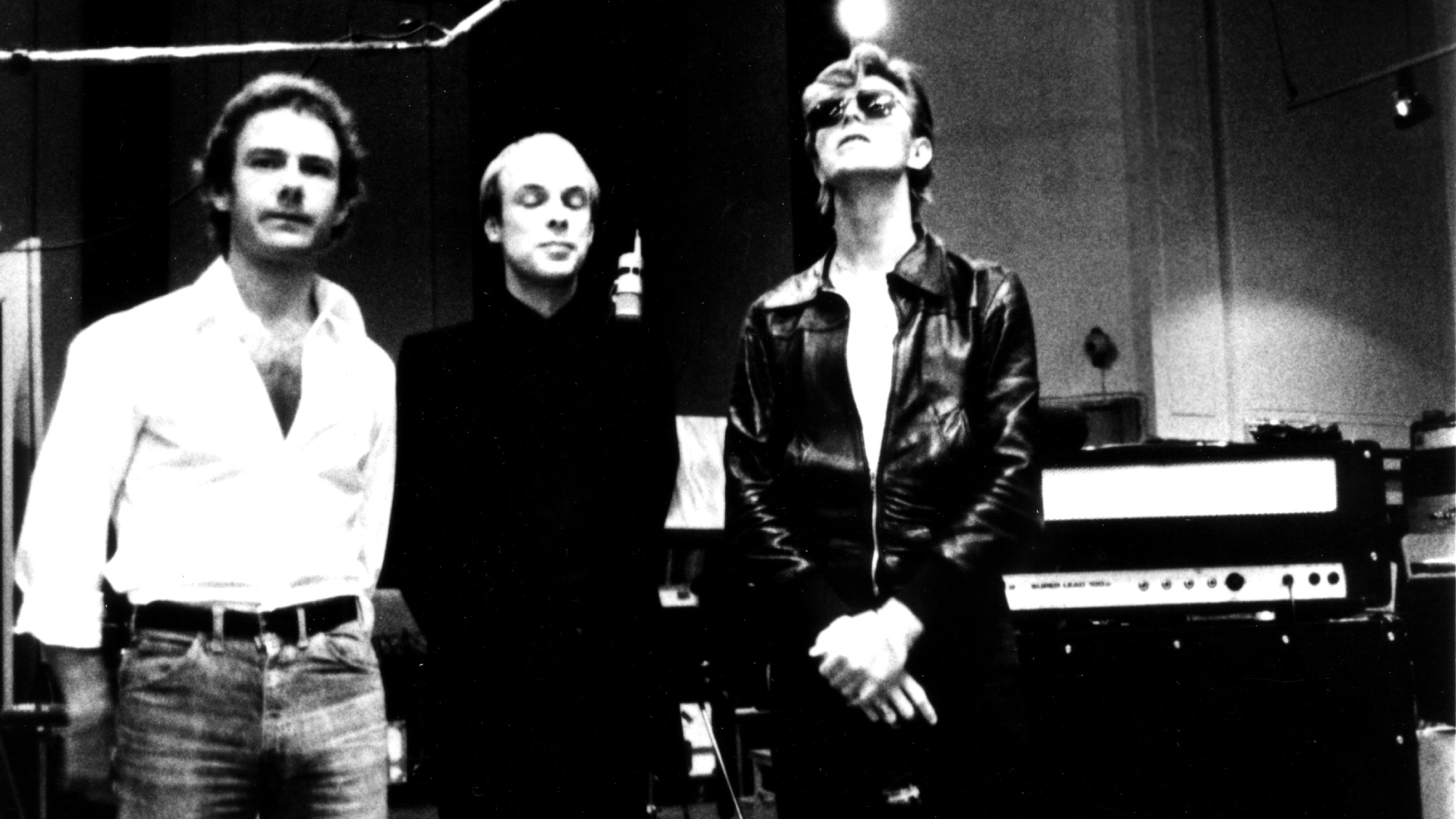 BERLIN - 1977:  Robert Fripp, Brian Eno and David Bowie pose for a portrait in the studio where they are recorded "Heroes" in 1977 in Berlin, Germany. 