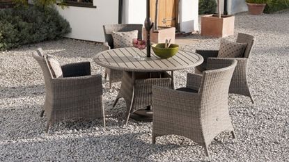 grey round dinning table and grey chairs at outdoor