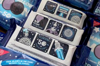 Marshmallow Moon Oreo cookie packs come with a set of three moon landing 50th anniversary stickers, with three sets available.