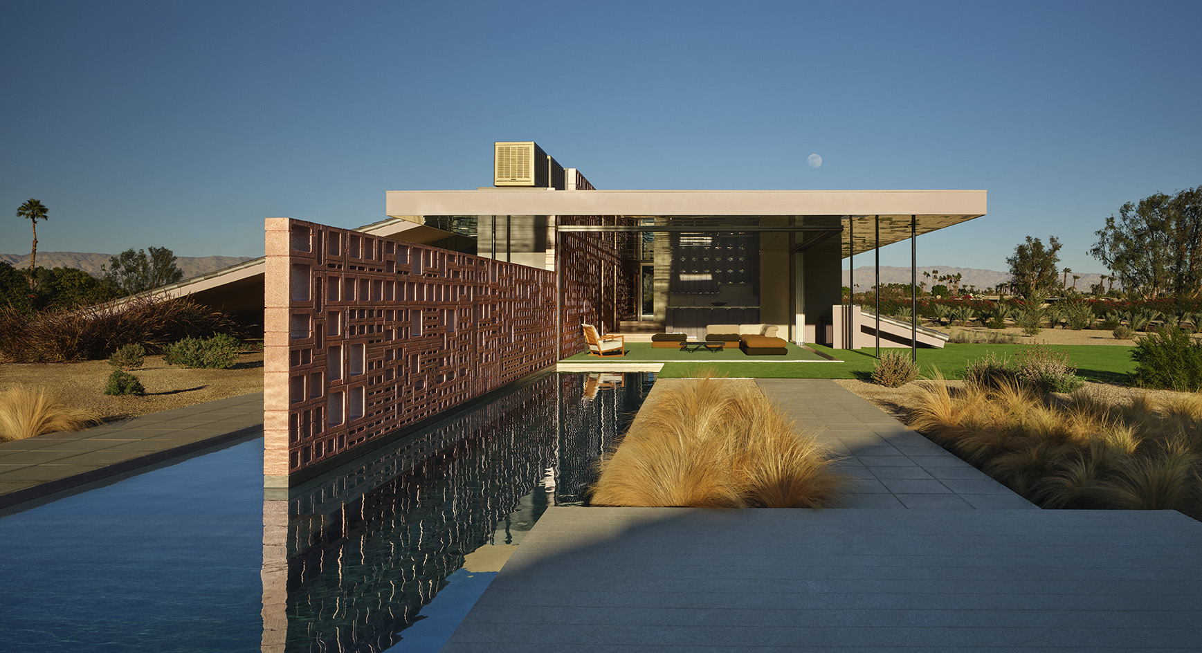 Desert house by Robert Stone, a home made with perforated partitions and an intense pitched low roof