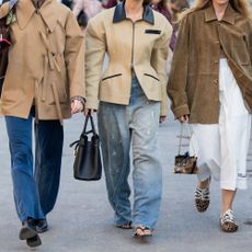a group of three women wear different denim trends