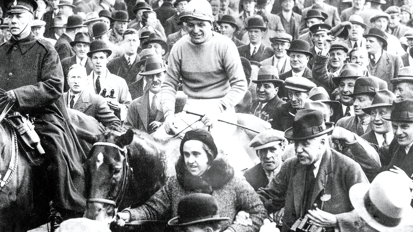 Miss Dorothy Paget, racehorse owner, leading in Golden Miller after winning the Grand National in 1934