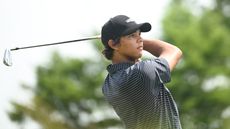 Charlie Woods hits an iron shot