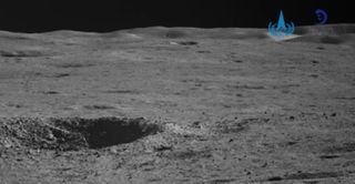 An impact crater and the distant wall of the moon's Von Kármán crater, imaged by China's Yutu 2 rover in January 2023.