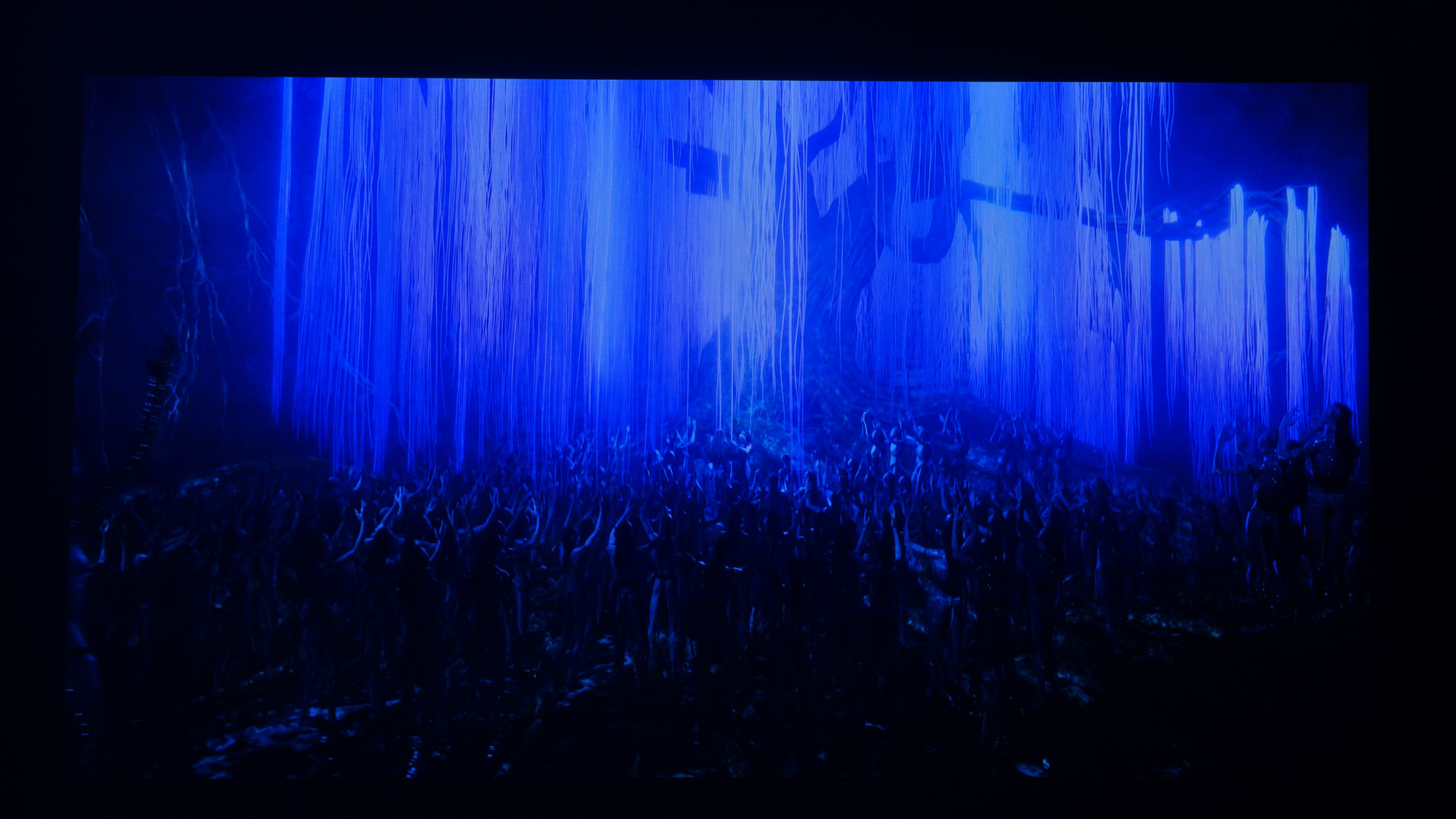 The projection from a JMGO N1S Ultimate projector displaying a dark scene from Avatar: The Way of Water.