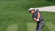Peter Malnati practices with a yellow golf ball at the Players Championship 2024